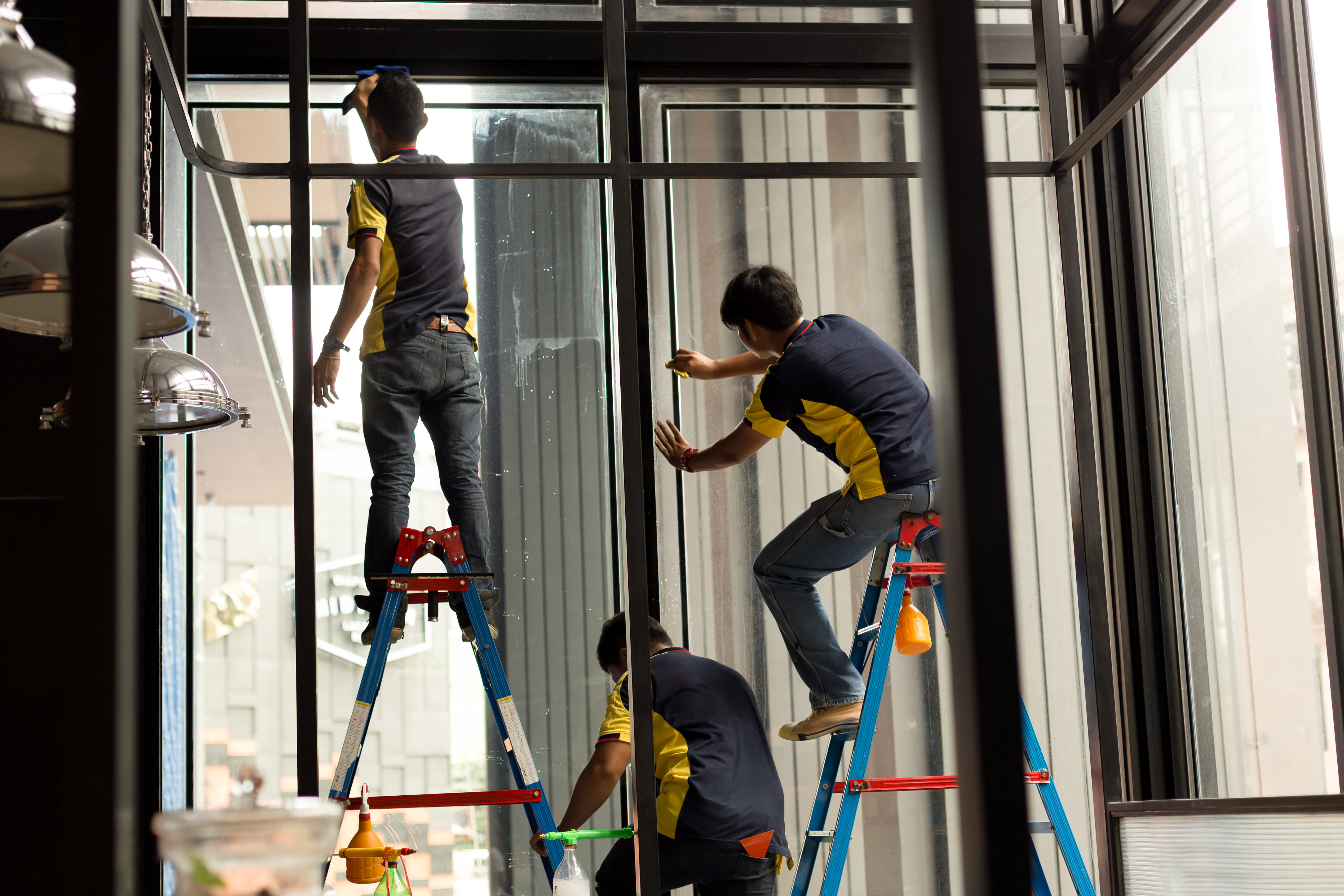 Worker Applying Tinted Layer On Glass Window